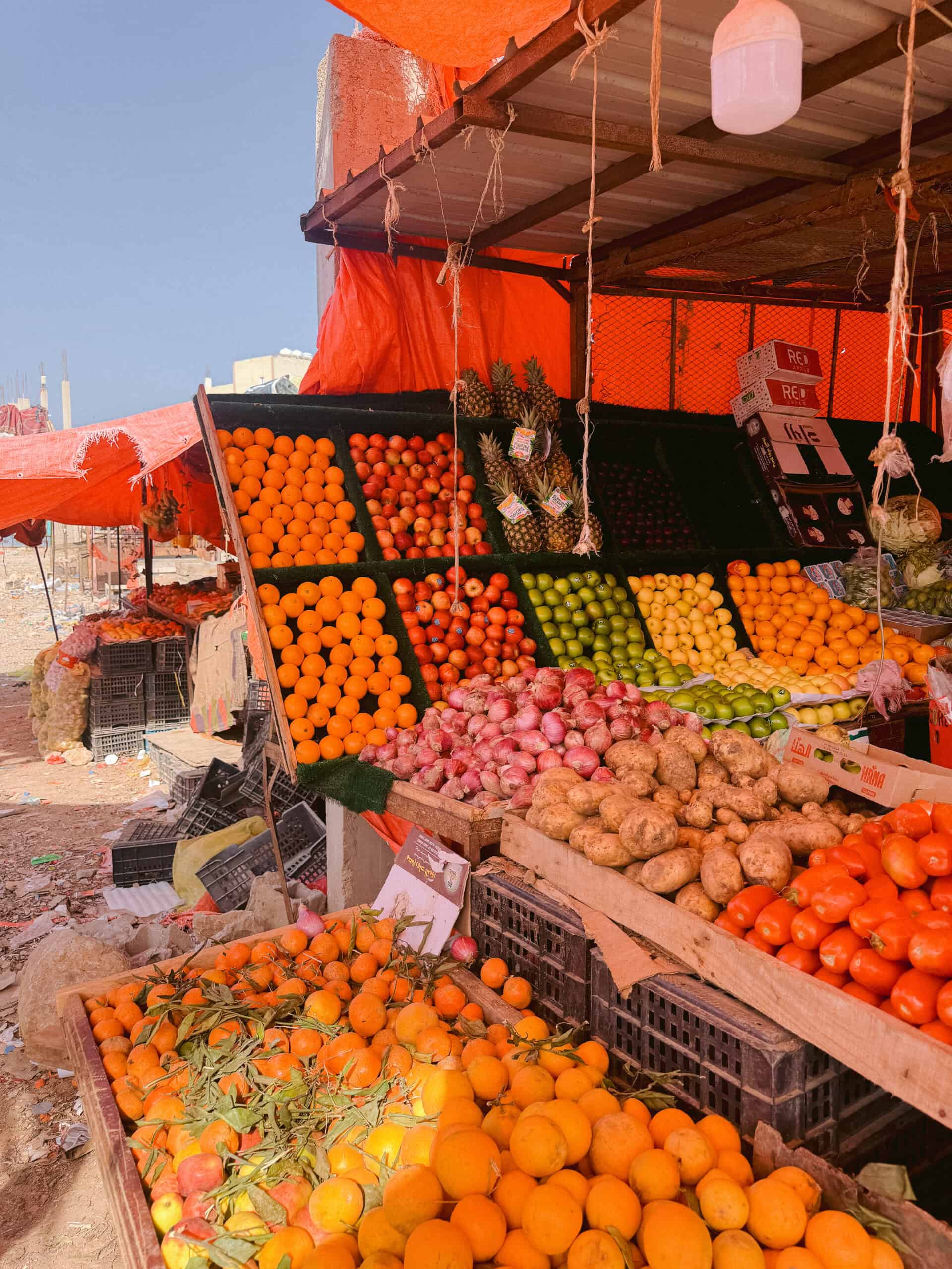 Colorful fruit market in Hadibo, Socotra Island, filled with fresh local produce like oranges, tomatoes, pineapples, and potatoes — a vibrant slice of island life