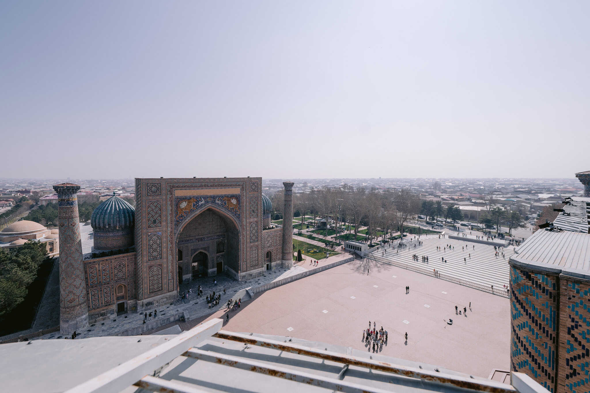 Aerial view of Registan Square in Samarkand, Uzbekistan with turquoise domes and Islamic architecture along the Silk Road.