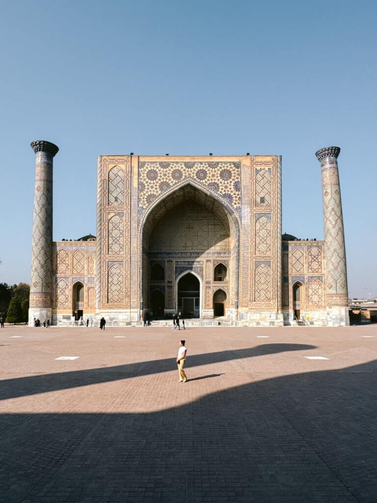 Woman standing alone in front of the Registan in Samarkand, showing that Uzbekistan’s most famous landmarks feel safe for women to explore.