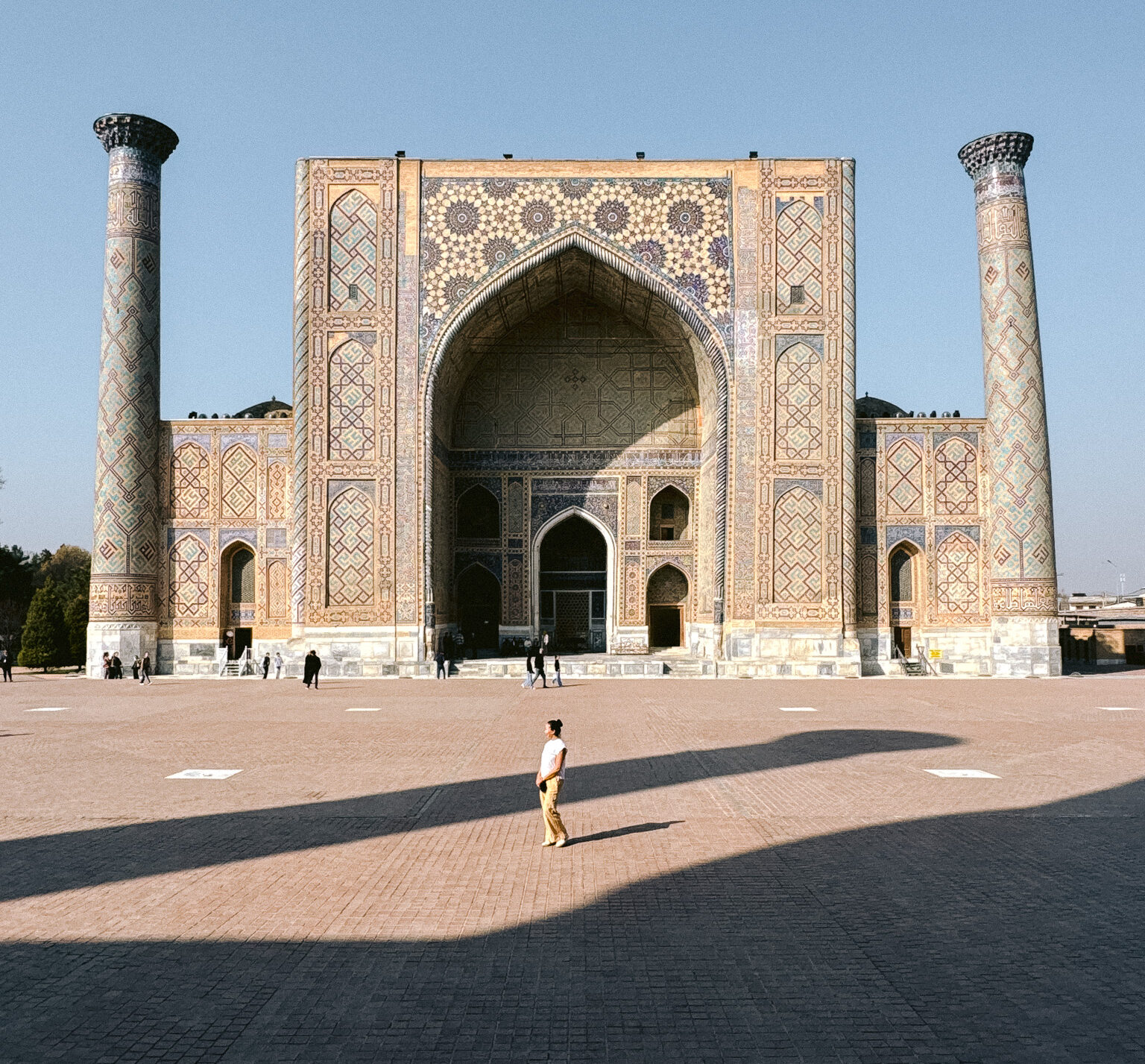 Woman standing alone in front of the Registan in Samarkand, showing that Uzbekistan’s most famous landmarks feel safe for women to explore.