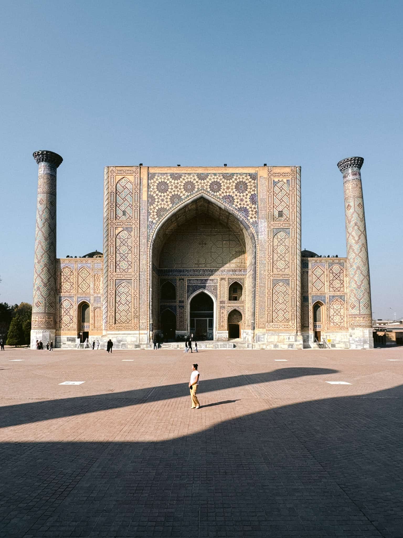 Woman standing alone in front of the Registan in Samarkand, showing that Uzbekistan’s most famous landmarks feel safe for women to explore.