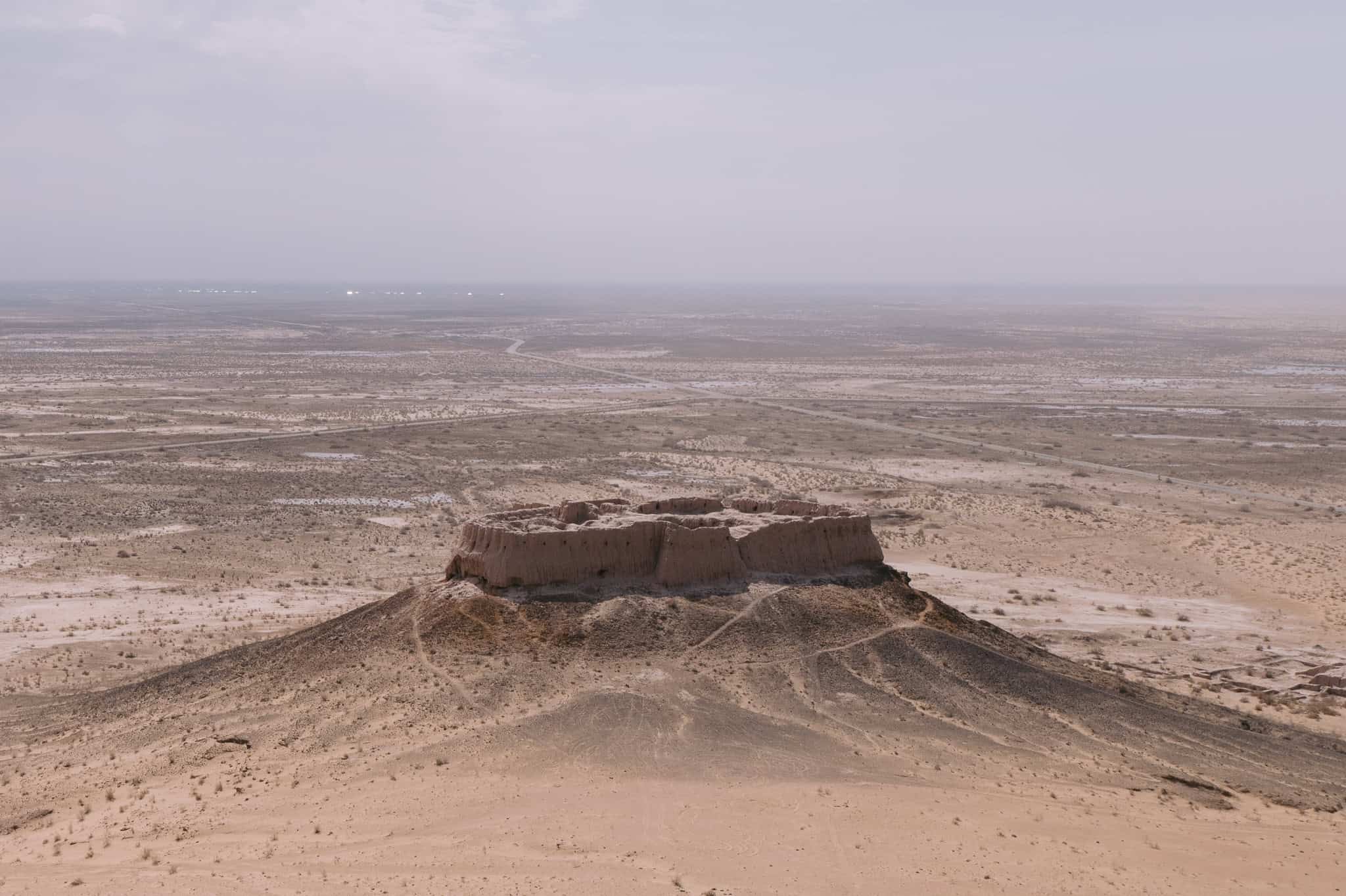 Ruins of Ayaz Qala fortress rising from the Karakalpakstan desert near Khiva — a fascinating day trip from the city.
