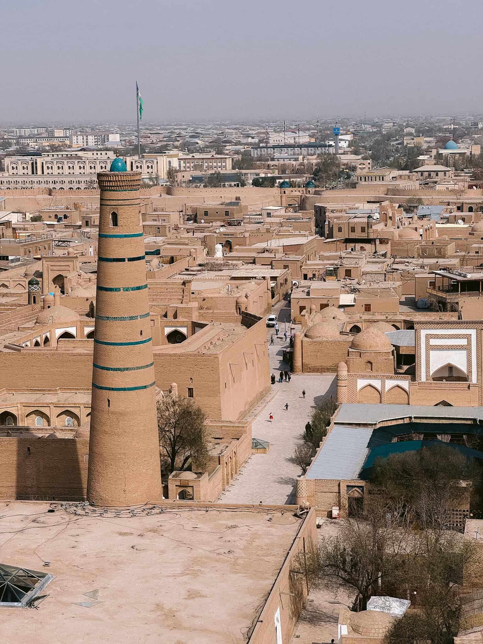 Aerial view of Khiva’s skyline with the tall Islam Khodja Minaret rising above the walled city — a must-see on any Khiva itinerary.