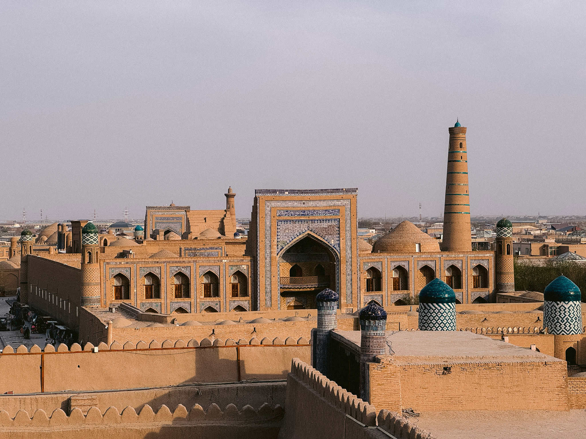 Panoramic skyline of Khiva’s Itchan Kala with blue domes, minarets, and madrassas — one of the best views in Uzbekistan.