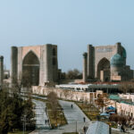 Panoramic view of Registan Square in Samarkand from across the park walkway