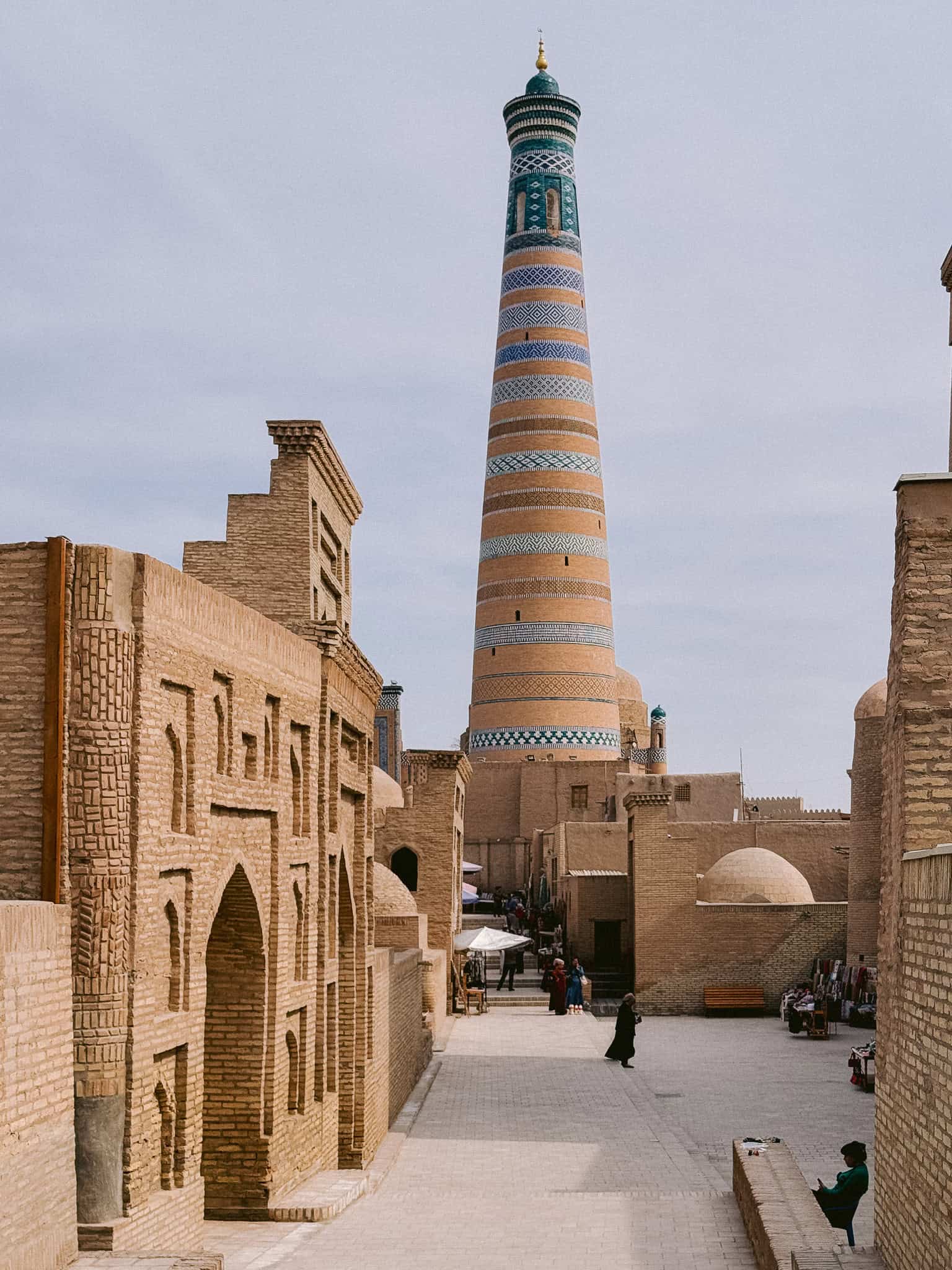 Street-level view of Kalta Minor Minaret surrounded by mudbrick architecture in Khiva’s old town